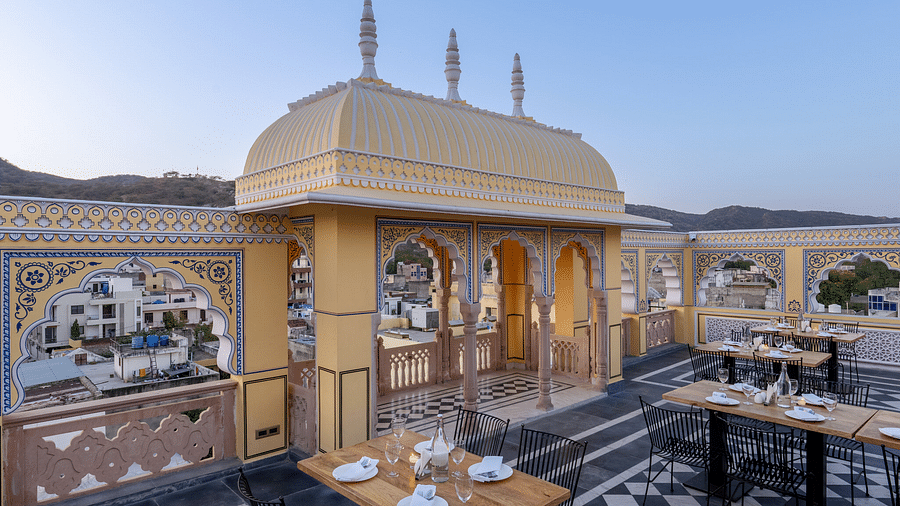 side view image featuring the balcony on the rooftop besides the dining area with three arched entrance - Brij Castle, Jaipur