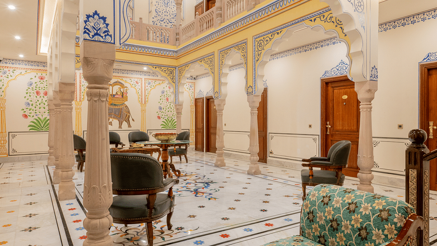 a beautiful image of the lobby of our hotel in jaipur with elegant furnishings and intricate wall paintings - Brij Castle, Jaipur