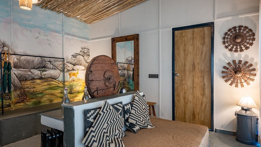 An image of a room with a couch and decorative items - Utsav Camp Sariska