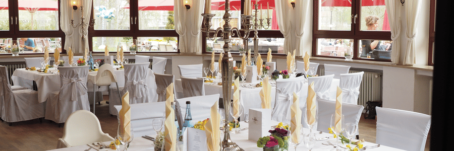 Elegantly set dining table with fine cutlery and tall candelabras inside the spacious restaurant at The Travancore Heritage Beach Resort, one of the best restaurants in Trivandrum