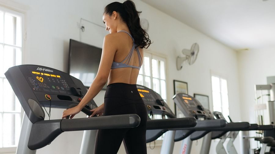 A woman is walking on a treadmill in a fitness centre | Central Mansions, Phnom Penh
