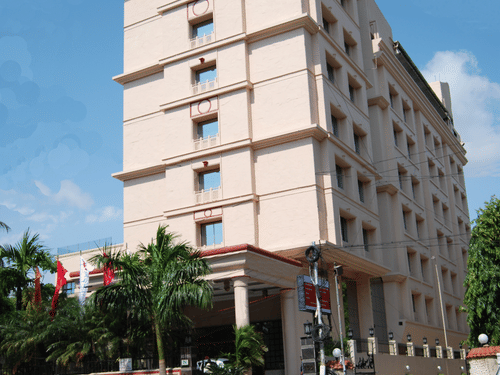 facade of Hotel raj Park, chennai with blue sky in the background