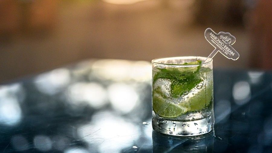 image of a glass kept with a refreshing drink with lemon wedges inside it - Maikhao Dream Villa Resort & Spa, Phuket
