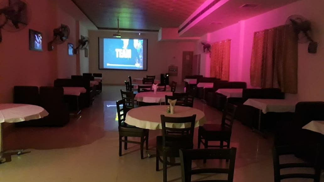 An image of a bar near IIT Roorkee decorated with cosy lights and tables - Motel Divine International, Roorkee