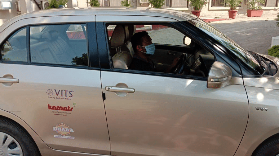 a close up shot of a car with the vits logo on it - VITS Hotels & Resorts