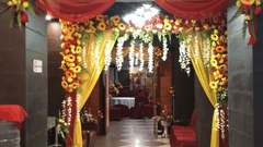 Elegant entrance décor with red drapes, yellow floral arrangements, and warm lighting at Central Courtyard Boutique Hotel.