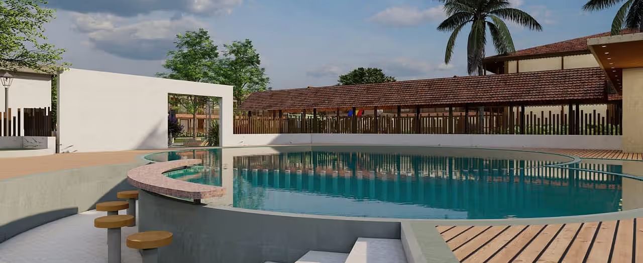 A resort with a pool area, including steps leading into the water and surrounding buildings, under a partly cloudy sky.| Ayana Resorts & Convention, Hyderabad