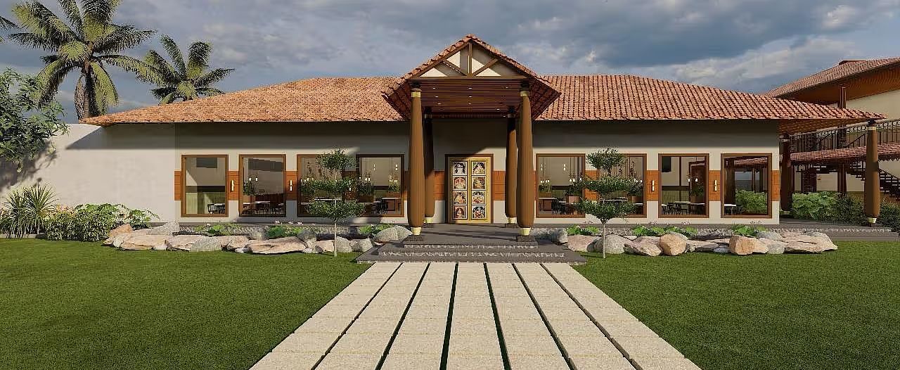 A resort building with a prominent entrance and a manicured lawn leading to it, set against a backdrop of palm trees and a cloudy sky| Ayana Resorts & Convention, Hyderabad