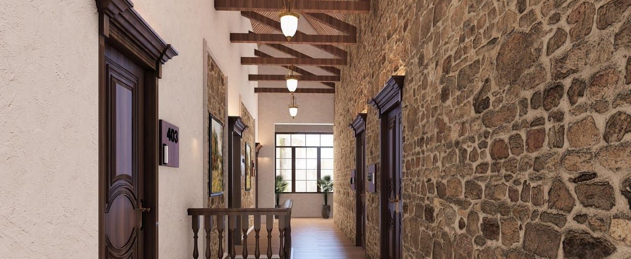 A stone-walled hallway with wooden beams and a staircase provides a rustic and inviting passage - BluSalzz Escapade Resort, Dalhousie