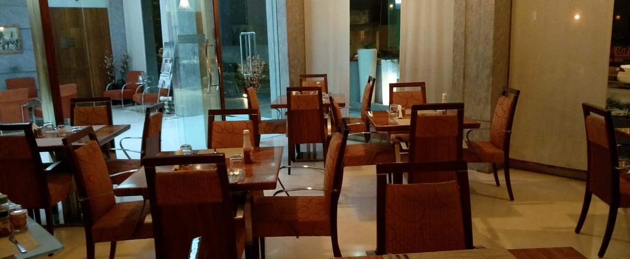 Dining setting of a restaurant at Regency Hotel, Mumbai.