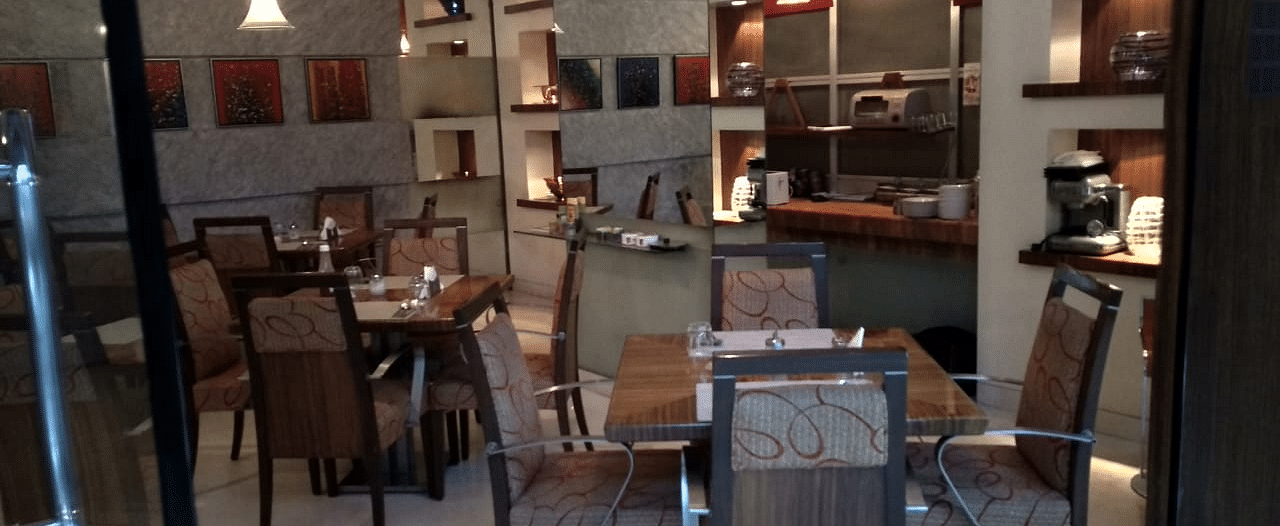 Dining setting of a restaurant at Regency Hotel, Mumbai.