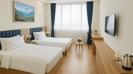 Side view of Executive Twin Room with cosy twin beds, wall-mounted TV, and a corner chair-table setup at Summit Norling Resort & Spa, Gangtok