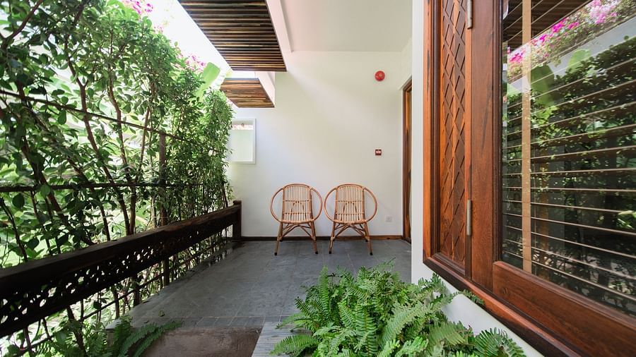 An image of a balcony which has trees on one side  - Alibu Resort Nha Thrang