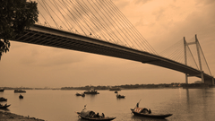 view of the howrah bridge and river hooghly running under it