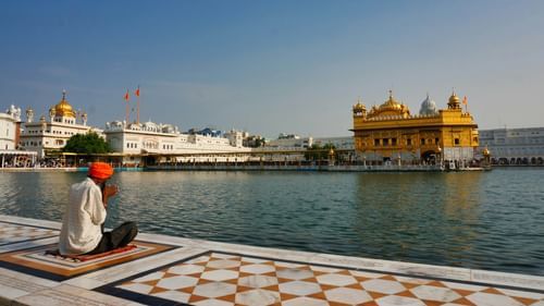 A serene view of the iconic Golden Temple with its reflection in the surrounding lake