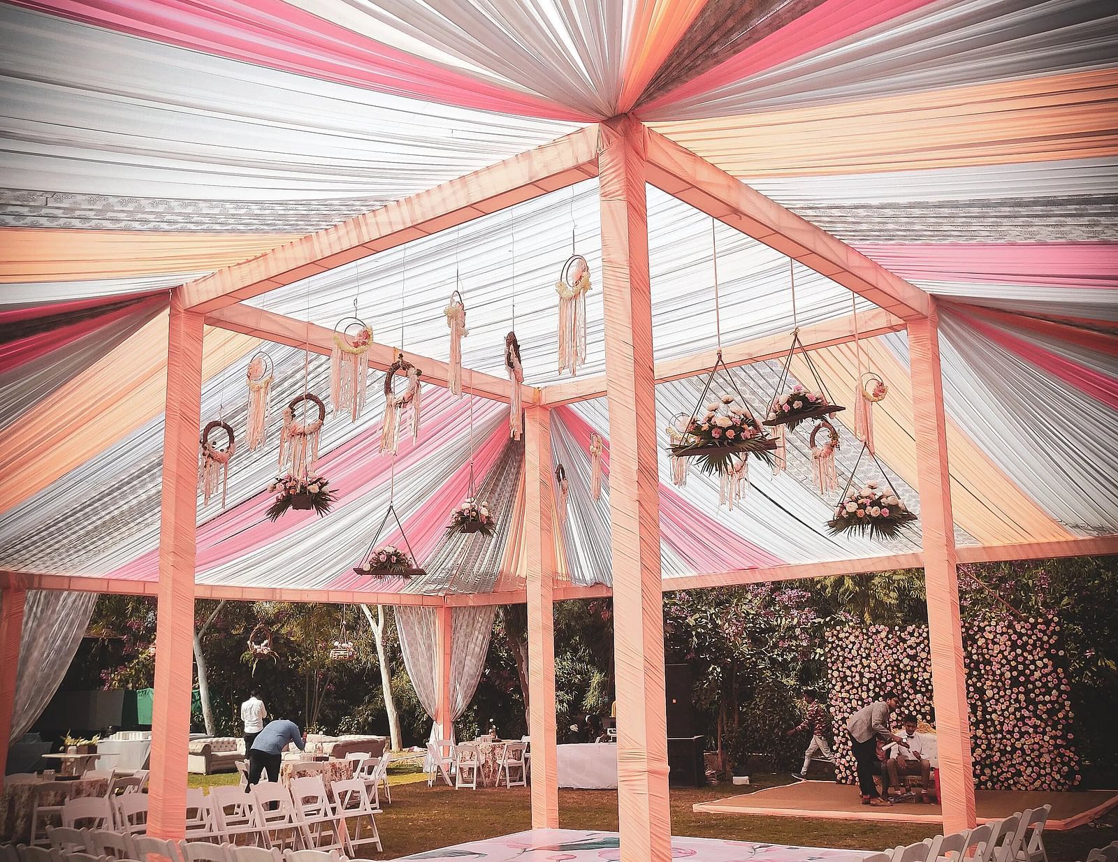 Outdoor event tent with colourful draped fabric ceiling, supported by a frame. - Bamboo Saa, Udaipur