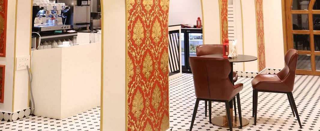 Chic indoor bistro with ornate wallpaper and elegant chandeliers