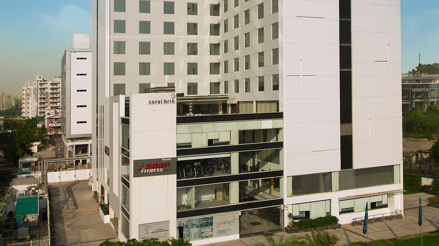 Full view facade image of the building of Ramada by Wyndham, Ghaziabad, Vasundhara facing the main road in front of it.