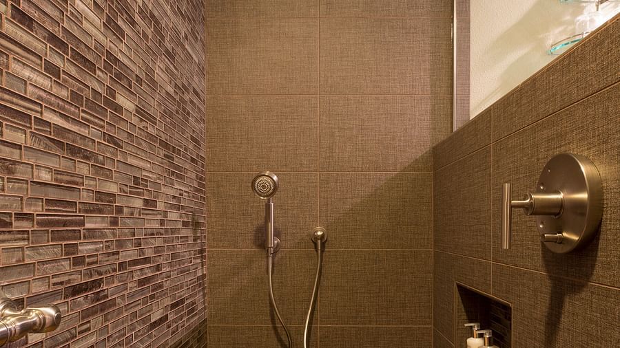 A shower area with wooden fixtures to sit on - Brewery Gulch Inn & Spa