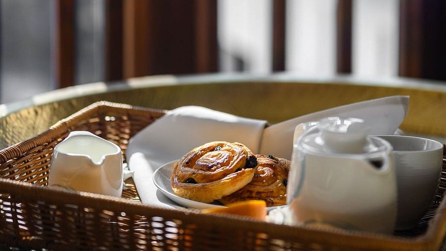 side view image featuring a wholesome breakfast assortment served on bed - Maikhao Dream Villa Resort & Spa, Phuket