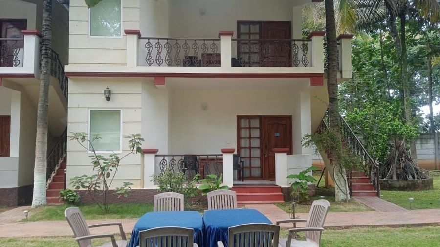 Two-storey building with balconies and lawn seating at Fantasy Golf Resort.