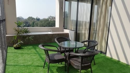 table and chairs in a balcony of one of the rooms at Hotel Polo Towers Agartala