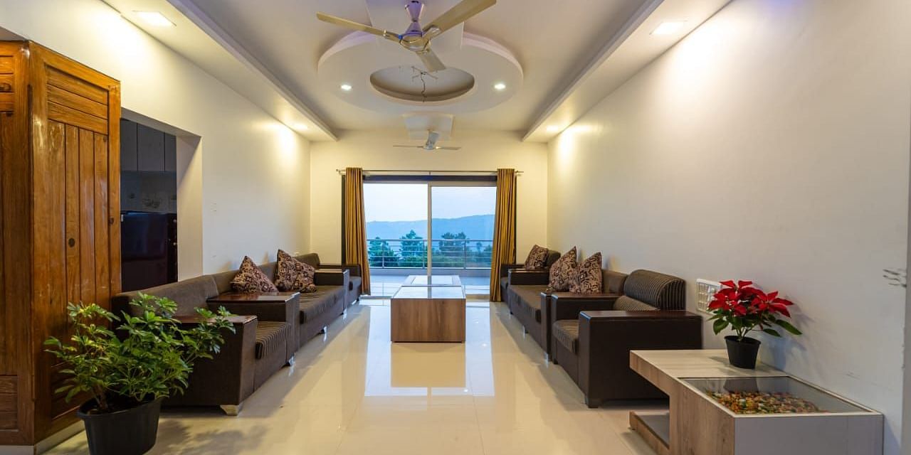 A hotel lobby with seating areas and a view to the outside.