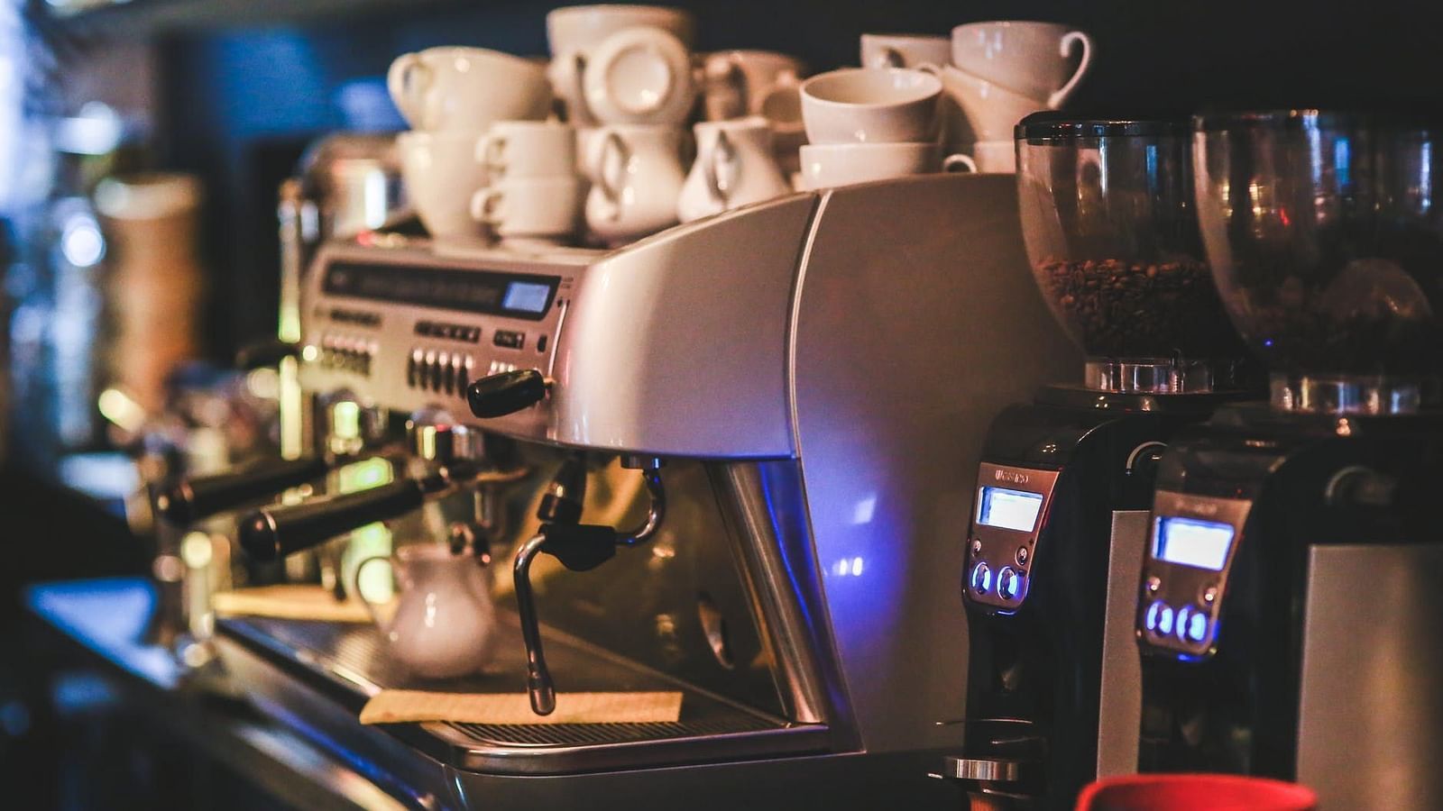 Image of a coffee machine with cups placed on top of it.
