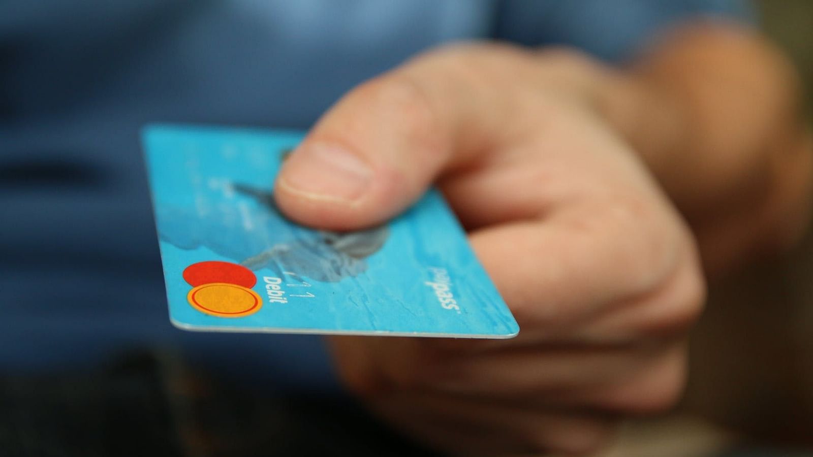Image of a hand holding a card.