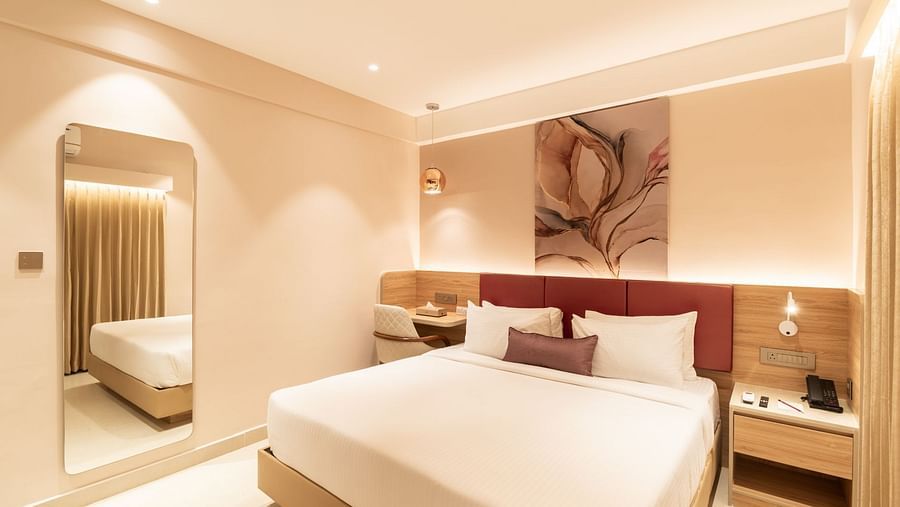 King-sized bed with elegant decor in The Premium Rooms at Livancia The Sojourn, Bangalore.