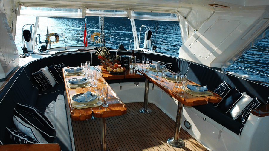 food tables set up inside a boat cruise with the ocean seen through the windows