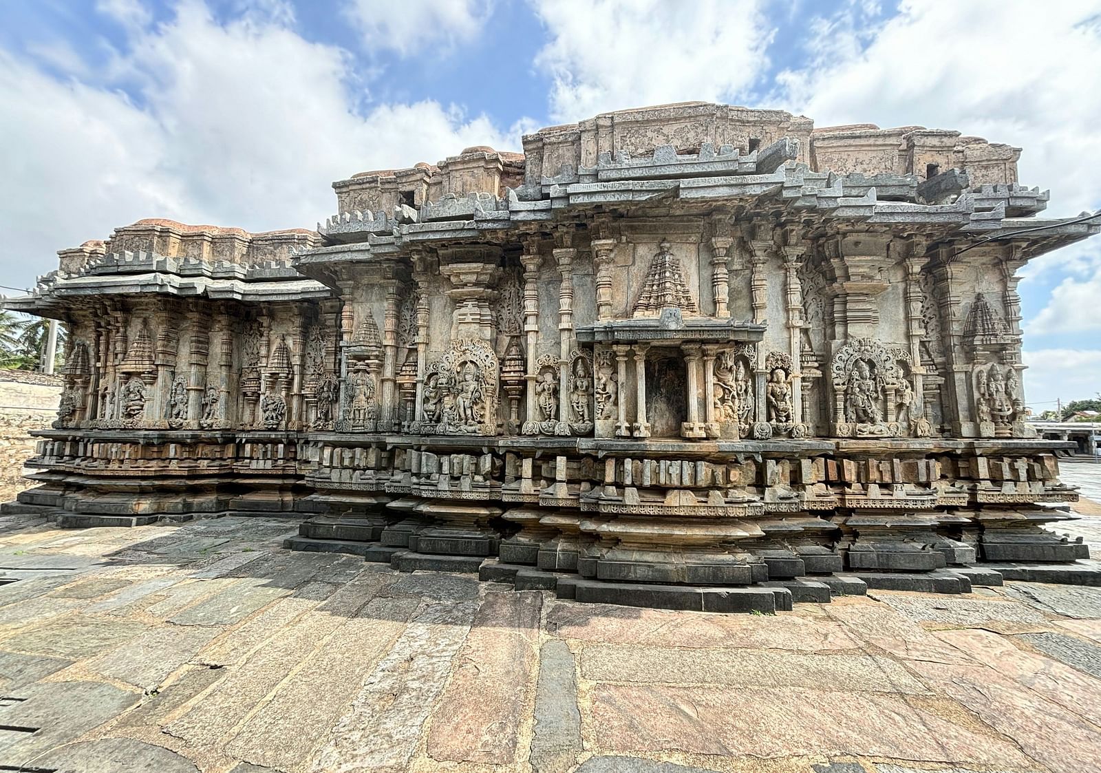Exterior photograph of an ancient stone temple with intricate carvings.