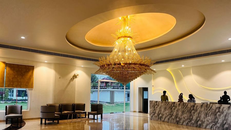 A reception area with four people standing behind the front desk at Valley by Grassfield.