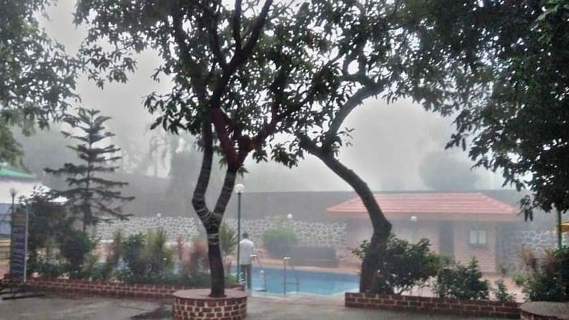 a mist-covered view of the swimming pool - Zara's Resort 1