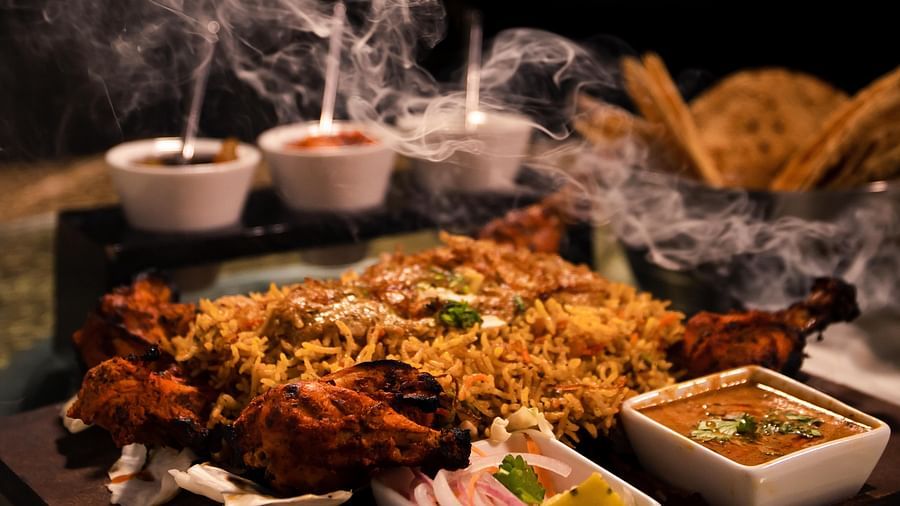 Chicken biryani served alongside some other dishes