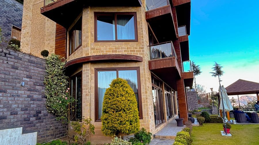 Charming villa exterior with manicured gardens and stone steps at Aranya Retreat, nestled in the Mashobra hills
