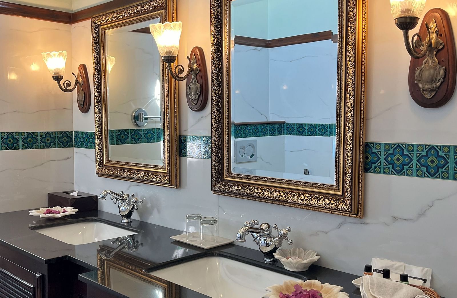 A traditional hotel bathroom with twin basins, a large mirror, and classic dark wood cabinetry - Khas Bagh, Jaipur.