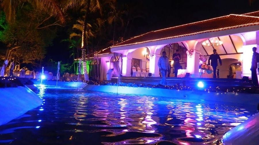 Illuminated poolside with seating and ambient lights at Fantasy Golf Resort.