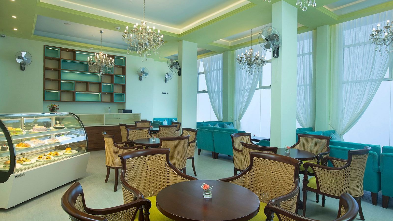 Coffee shop at Fragrant Nature Munnar with neat seating and bakery items ready to be savoured