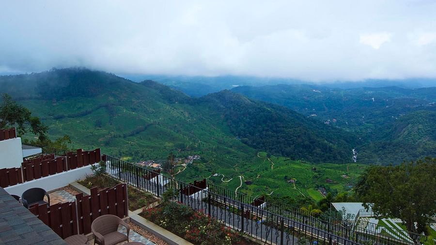Half cloudy sky and mountain view from the balcony at Fragrant Nature Munnar.