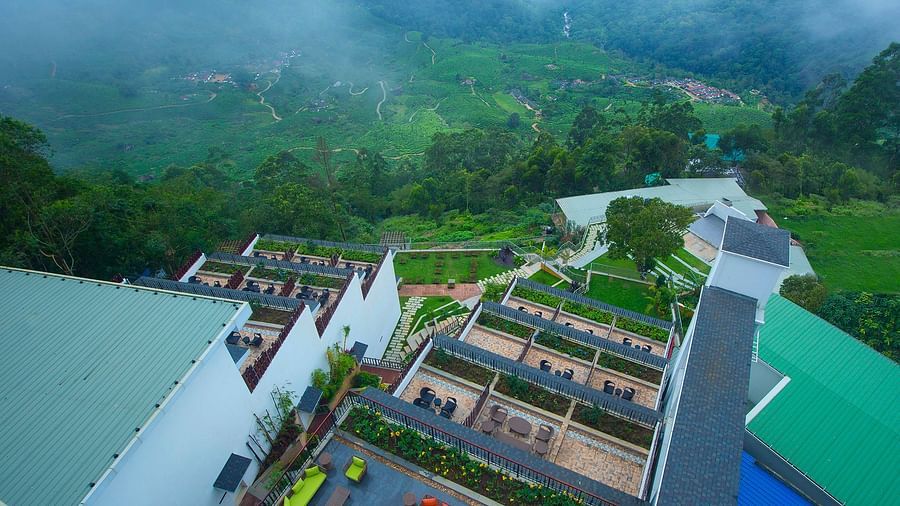 Facade view of Fragrant Nature Munnar illuminated at night.