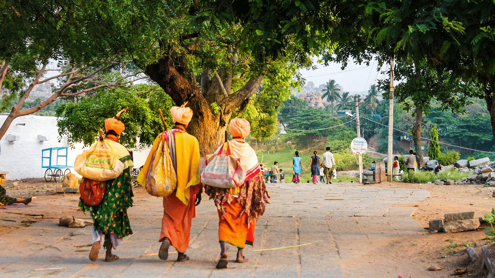 an image of three people walking down the street