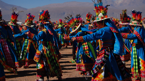Group of men wearing colourful attire dancing in a synchronised manner
