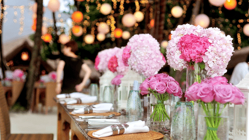 a table decorated with flowers and plates for a special occasion
