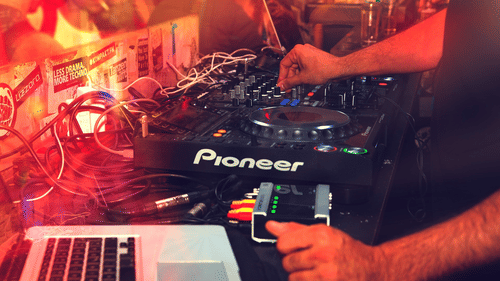 A DJ mixing up using a controller