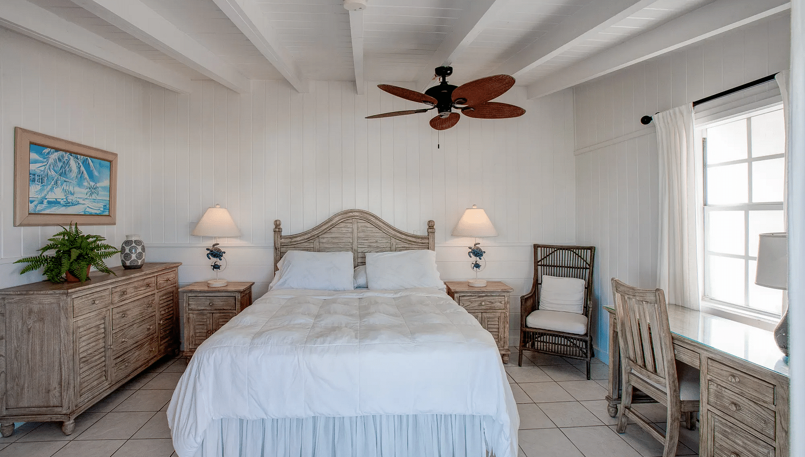Bedroom with a double bed, ceiling fan, and natural light | Abaco Inn
