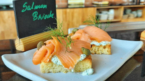 Plate of salmon bruschetta served at a restaurant.