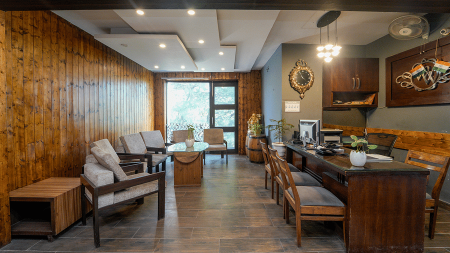 The reception at DLS Whispering Winds with the reception desk and chairs, and the waiting area featuring sofa set and table