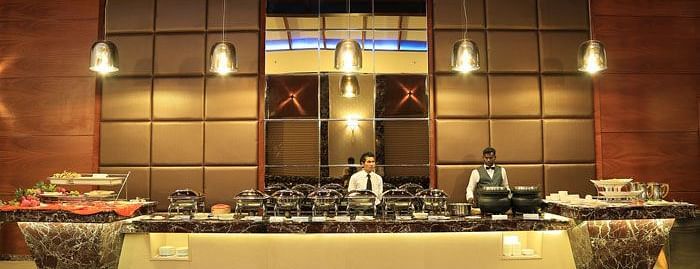 A live buffet station with chefs in action, offering a wide selection of gourmet dishes in an elegant setting. - Dhanalakshmi Srinivasan Hotels, Perambalur