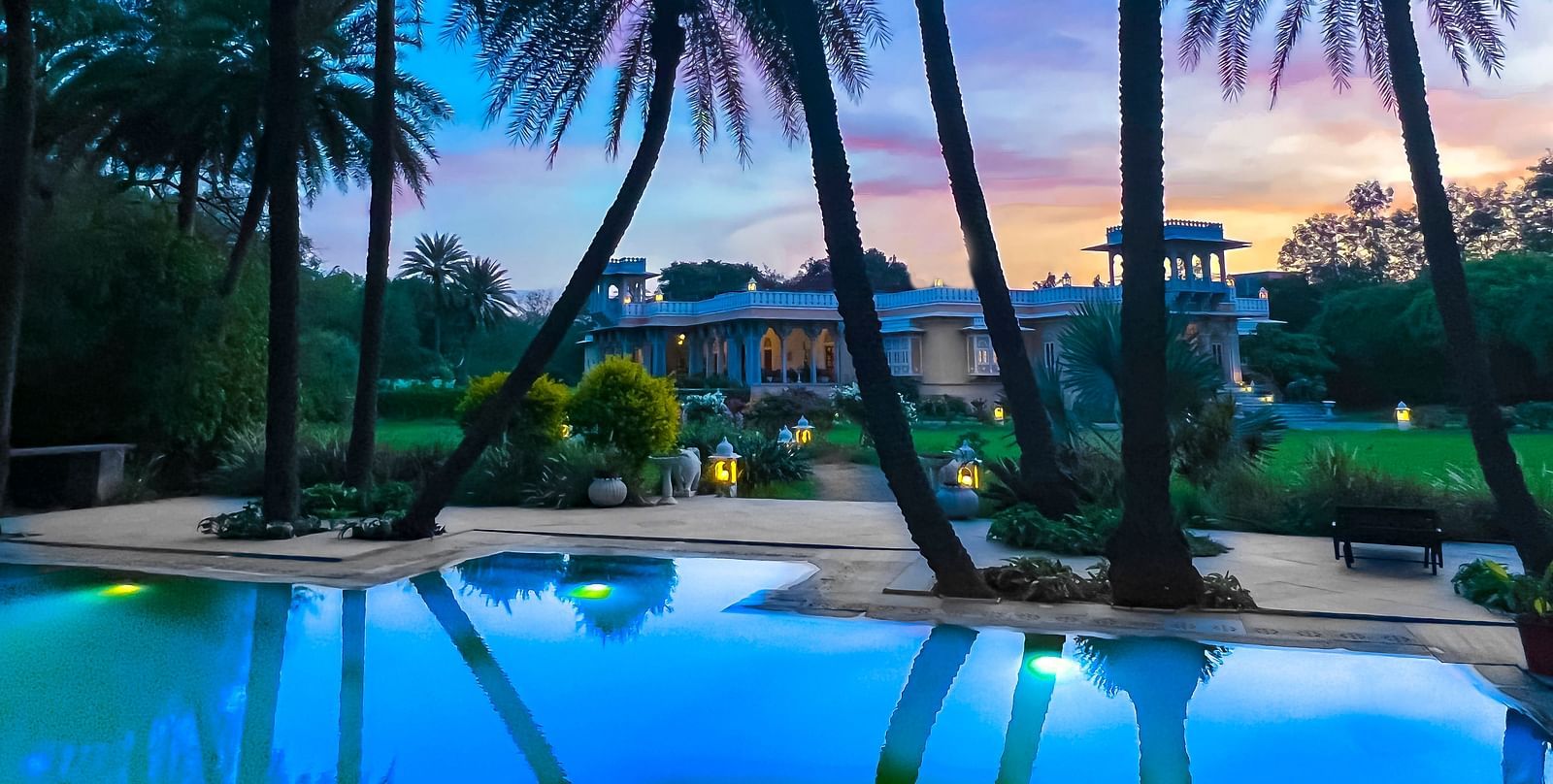 image of the swimming pool at Dev Shree, Deogarh with a picturesque background